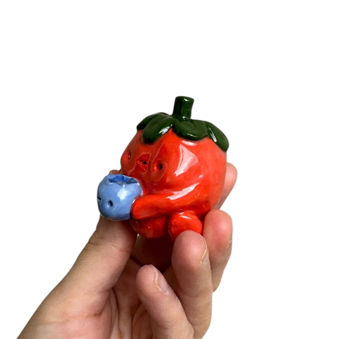 Strawberry holding Blueberry