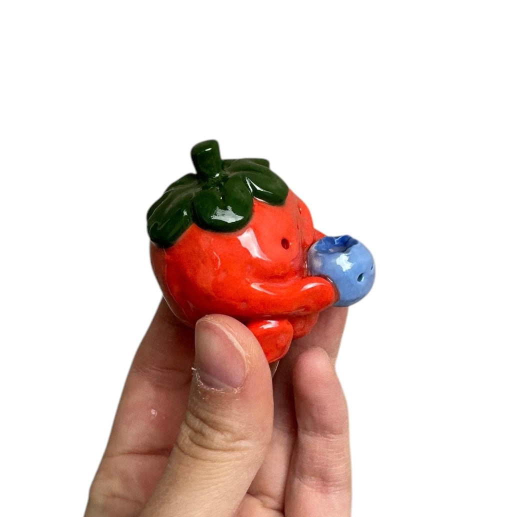 Strawberry holding Blueberry